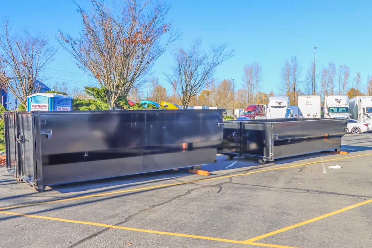 Professional dumpster rental service with roll-off container on residential driveway in Menominee
